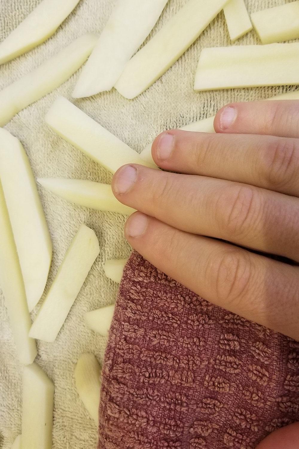 Pat potatoes dry with a clean dishcloth if making french fries. 