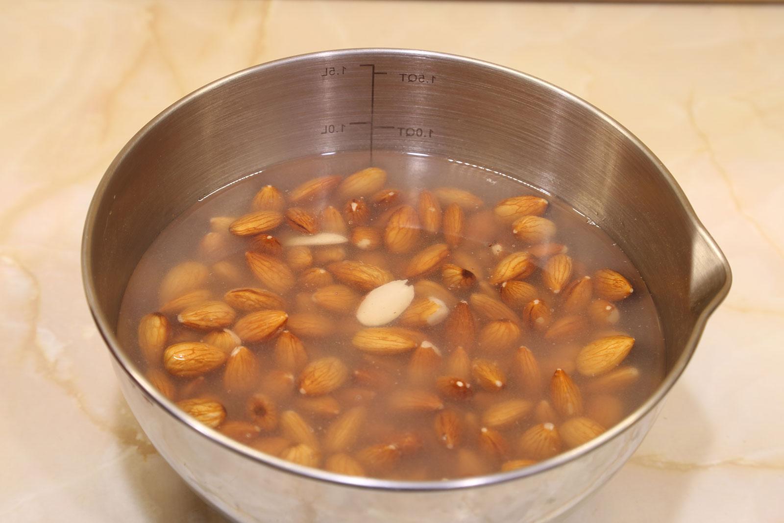 Strain the cloudy water from the almonds and rinse with fresh water.